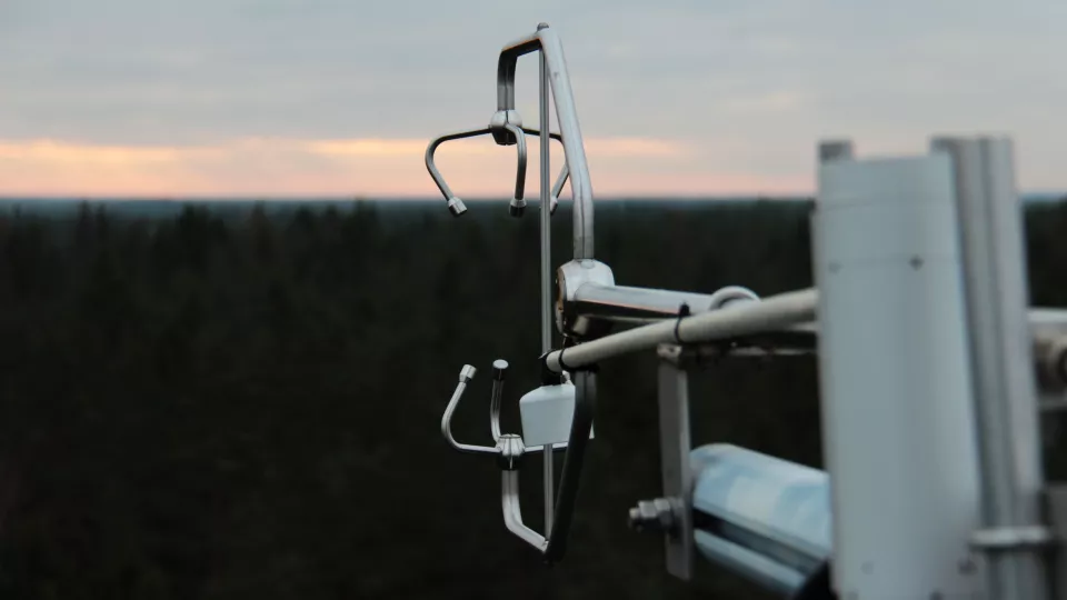 Outdoor view of measuring equipment, sky and forest in the background. Photo.