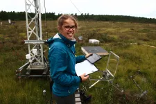 Young woman in peatland with research equipment. Photo.