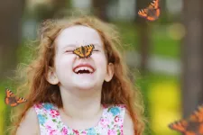 A girl with a butterfly on her nose. Photo.