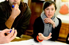 People discussing around a table. Photo.